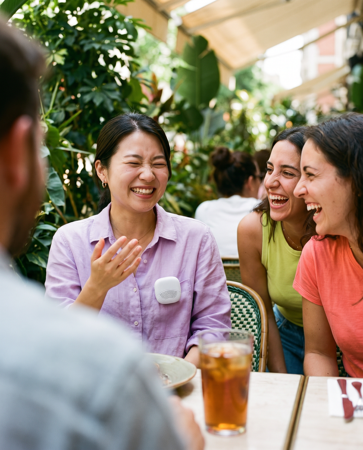 Japanese woman telling a story to two laughing Spanish friends