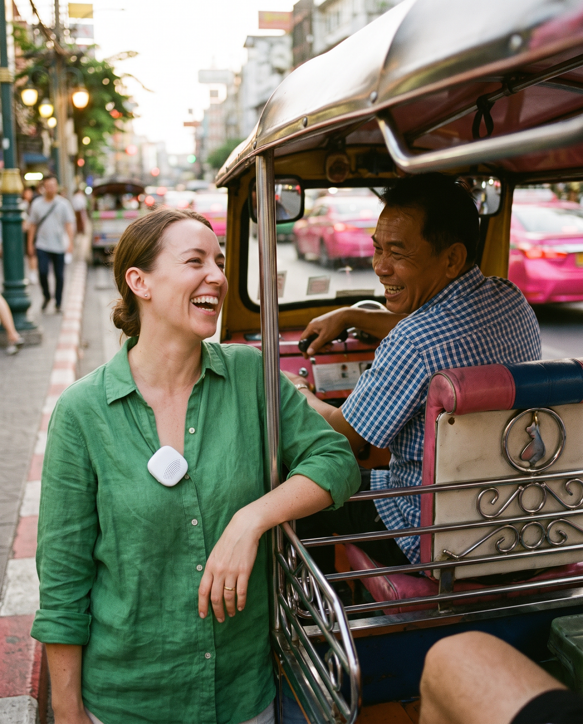 Traveller laughing with a tuk-tuk driver in Bangkok